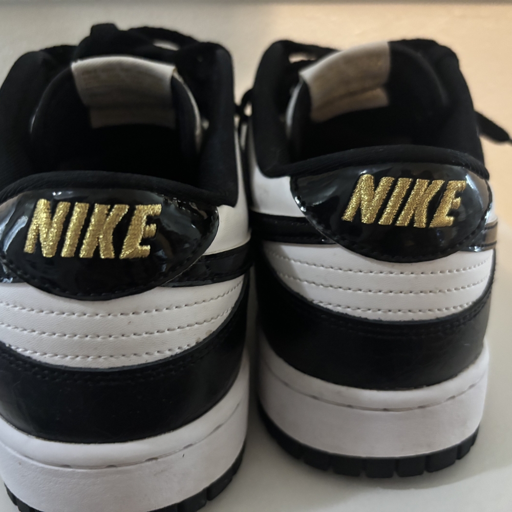 Nike Black and White Sneakers with Gold Accents - Picture 3 of 5